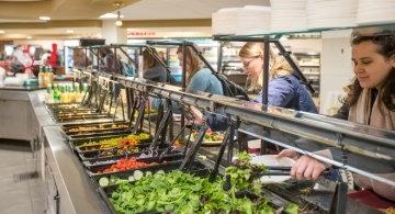 Students serving themselves at salad bar